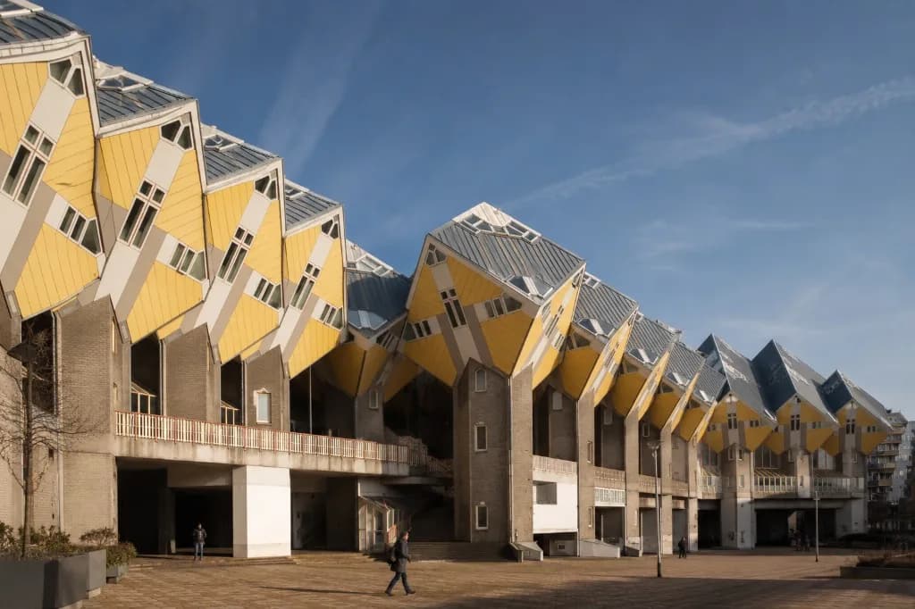 Cube Houses Rotterdam: yellow tilted Kubuswoningen by Piet Blom on Overblaak under a blue sky